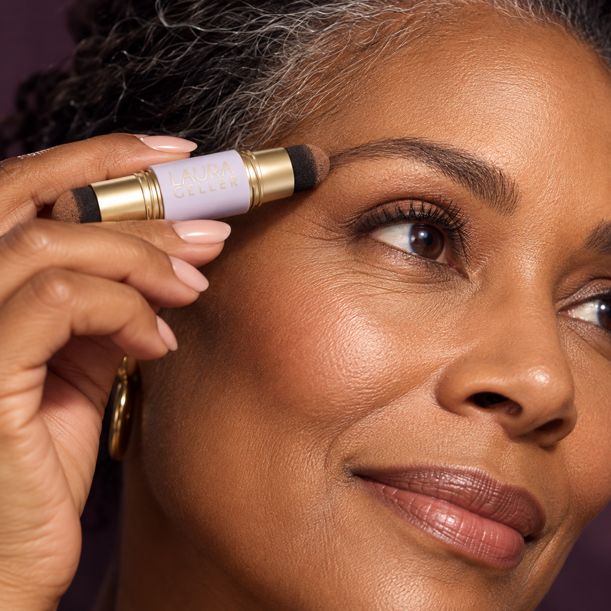 A woman lightly applying the dual-ended product to a sparse-looking brow area.